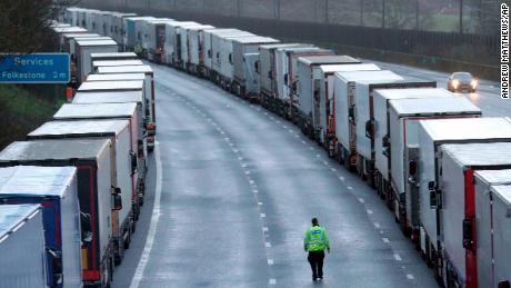 Police patrol along the M20 motorway where freight traffic is parked whilst the port of Dover remains closed on Tuesday.