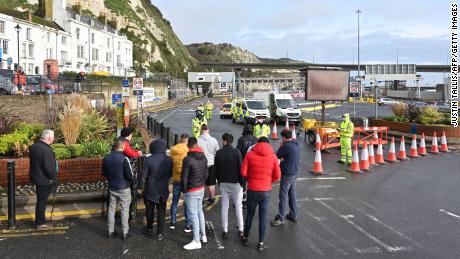 Drivers gather at the cordon blocking the entrance to the ferry terminal at the port of Dover in Kent, southeast England on Tuesday.