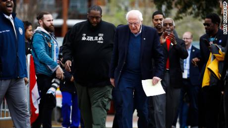 Killer Mike walks with Sen. Bernie Sanders before a campaign event in February, ahead of the presidential primary. 