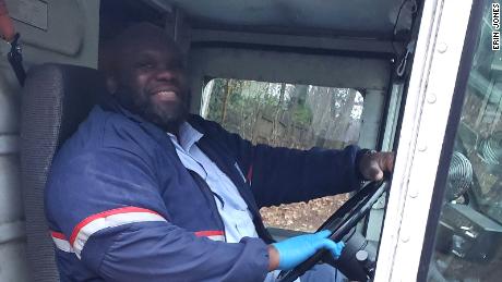 Mail carrier Adam Finley plays Tic-tac-toe with kids on his route.