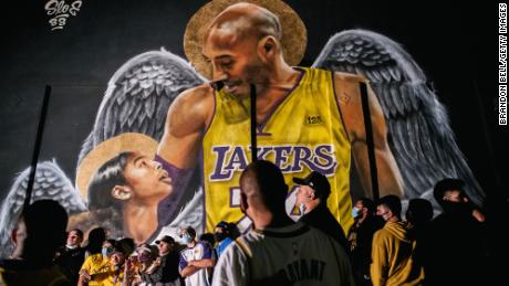 Lakers fans stand in line to celebrate in front of a mural of Kobe Bryant and his daughter on October 11, 2020 in Los Angeles, California.