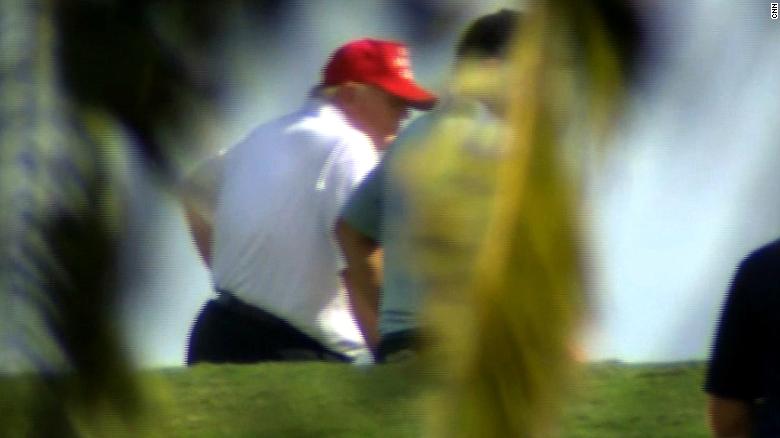 Trump seen golfing after vowing to 'work tirelessly'