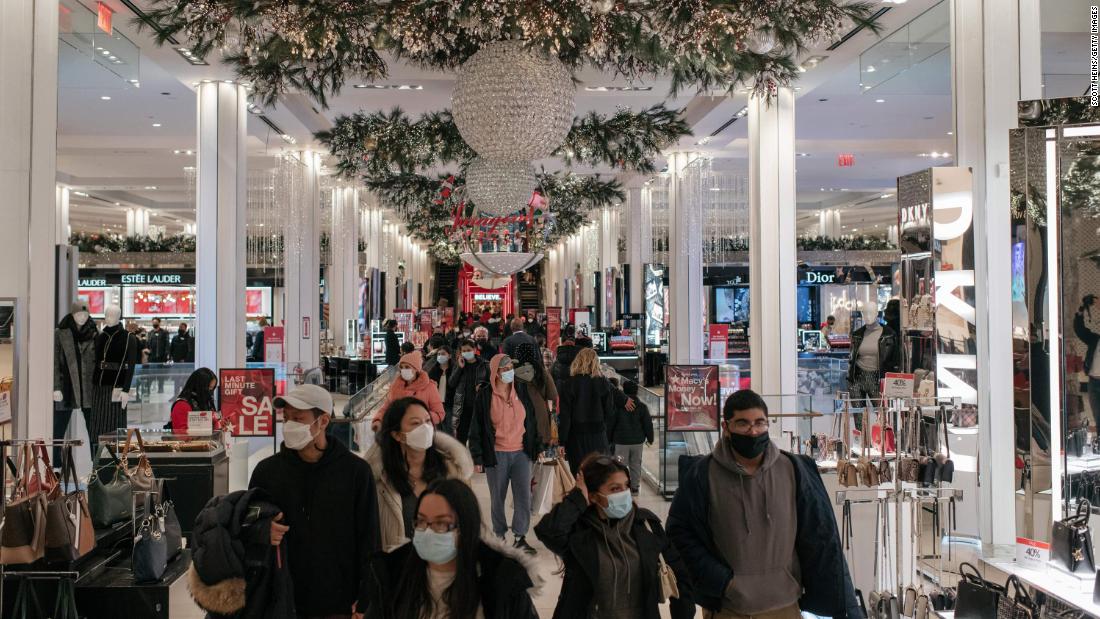 Shoppers walk through Macy&#39;s flagship department store in New York City on December 24.
