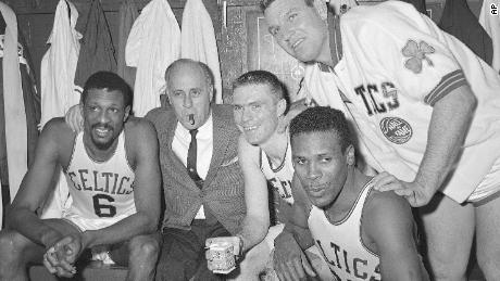This April 9, 1964 photo of Goston, Boston Celtics, from left, Phil Russell, Coach Red Aurbach, Tommy Heinzone, Jim Locustoff and KC Jones celebrating in the locker room at Boston Garden after winning the eighth division division playoff title in Boston. 