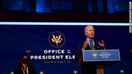 President-elect Joe Biden delivers remarks as Vice President-elect Kamala Harris listens at the Queen Theater on December 28, 2020 in Wilmington, Delaware. 
