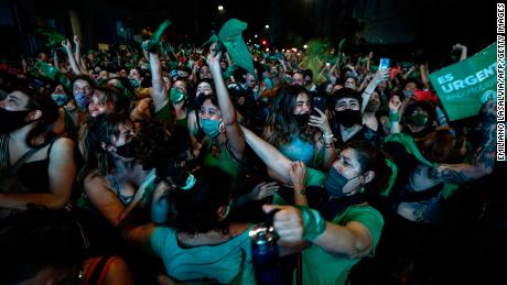 Abortion rights activists celebrate in Buenos Aires after Argentina's Senate approved a bill to legalize abortion up to 14 weeks in December 2020. 