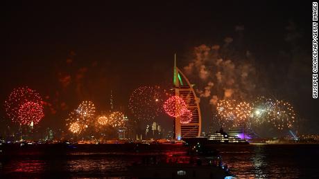 New Year&#39;s fireworks celebrations are seen above the Dubai skyline with the Burj Al Arab (R) and Burj Khalifa (L), the world&#39;s tallest building, on December 31, 2019. 