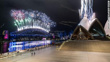 The Sydney Harbour fireworks display is seen over a near-empty Sydney Opera House.