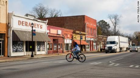 A man rides a bike through downtown Sparta last month. 