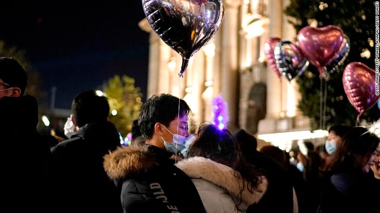 A couple kiss as New Year approaches on December 31, 2020 in Wuhan. 