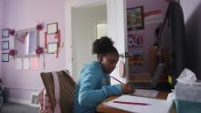 Fourth grader Miriam Amacker does schoolwork in her room at her family&#39;s home in San Francisco.