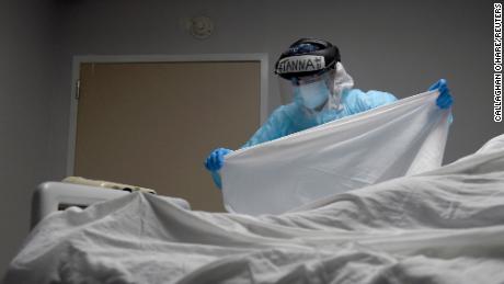 FILE PHOTO: Tanna Ingraham places a sheet over the body of a patient who died inside the coronavirus disease (COVID-19) unit at United Memorial Medical Center in Houston, Texas, U.S., December 30, 2020.  REUTERS/Callaghan O&#39;Hare/File Photo