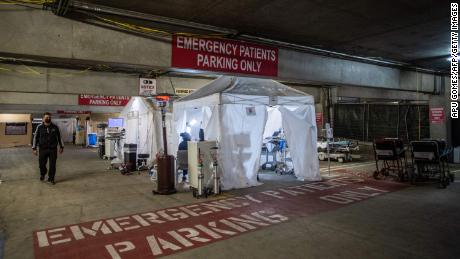 Thomas Yadegar, Medical Director of the Intensive Care Unit, steps inside a temporary emergency room on January 3, 2021, built into a parking garage at Providence Cedars-Sinai Tarzana Medical Center in Tarzana, California.