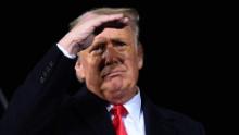 TOPSHOT - US President Donald Trump looks on during a rally in support of Republican incumbent senators Kelly Loeffler and David Perdue ahead of a Senate runoff in Dalton, Georgia on January 4, 2021. - President Donald Trump, still seeking ways to reverse his election defeat, and President-elect Joe Biden converge on Georgia on Monday for dueling rallies on the eve of runoff votes that will decide control of the US Senate. Trump, a day after the release of a bombshell recording in which he pressures Georgia officials to overturn his November 3 election loss in the southern state, is to hold a rally in the northwest city of Dalton in support of Republican incumbent senators Kelly Loeffler and David Perdue. (Photo by MANDEL NGAN / AFP) (Photo by MANDEL NGAN/AFP via Getty Images)