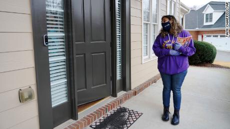 Stephanie Lopez-Burgus talks to a voter while canvassing in Lawrenceville, Georgia.