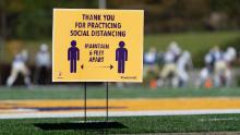 COLUMBIA, SC - DECEMBER 05: A sign encourages social distancing as Southside Christian plays Lake View during the South Carolina High School League Class A football championship game at Benedict College on December 5, 2020 in Columbia, South Carolina. The Class AA championship game, between Abbeville and Marion originally scheduled for December 4, was postponed after a team quarantine for COVID-19. (Photo by Sean Rayford/Getty Images)