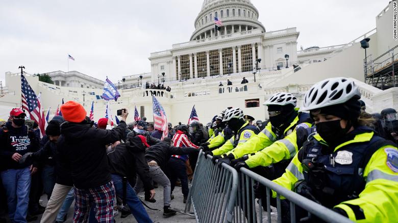 Trump supporters try to break through a police barrier, Wednesday, Jan. 6, 2021, at the Capitol in Washington. As Congress prepares to affirm President-elect Joe Biden&#39;s victory, thousands of people have gathered to show their support for President Donald Trump and his claims of election fraud. (AP Photo/John Minchillo)