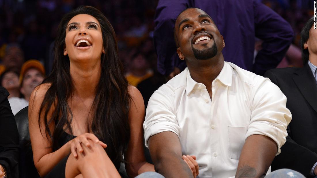 Kim and Kanye watch the video board as they sit courtside at an NBA game in Los Angeles in May 2012.