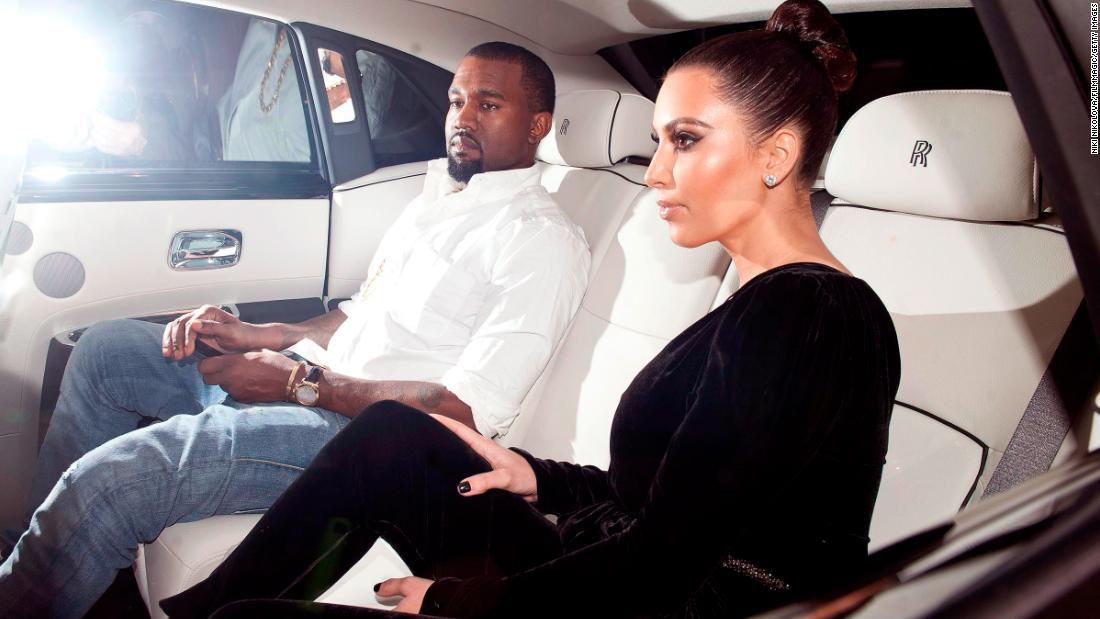Kim and Kanye sit in the back seat of a vehicle while in London in November 2012.