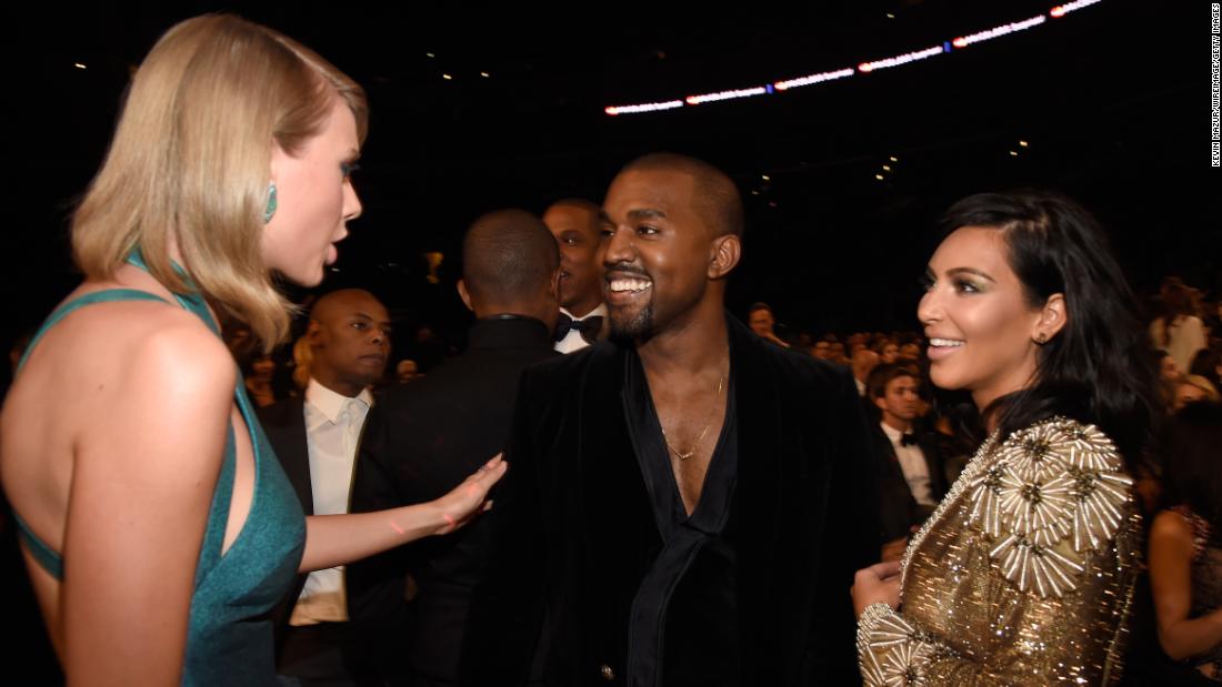 Singer Taylor Swift talks to Kanye at the Grammy Awards in February 2015.
