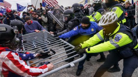 Trump supporters try to break through a police barrier on January 6 at the Capitol in Washington. 