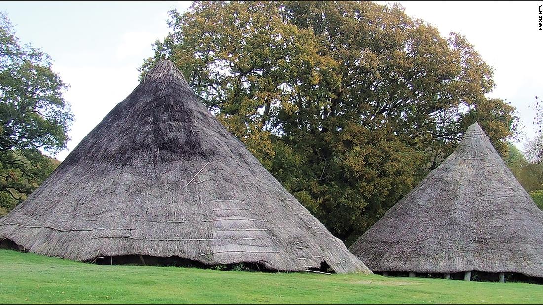 This image shows the Cook House (right) and the Earthwatch roundhouse reconstructions (left) prior to their dismantling and excavation at the Castell Henllys Iron Age site in Wales.