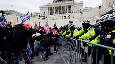 Trump supporters try to break through a police barrier, Wednesday, Jan. 6, 2021, at the Capitol in Washington. (AP Photo/Julio Cortez)