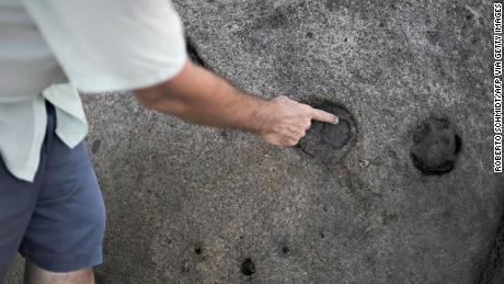 TO GO WITH AFP STORY Jean-Marc Mojon Seychellois history teacher John Cruise-Wilkins points to markings on a rock just yards from his beachfront home where the ebbing turquoise sea laps at a keyhole-shaped marking his father found while in search for a long lost pirate treasure in the Island of Mahe in the Seychelles on November 28, 2009. Cruise-Wilkins has spent much of his life, as did his father before him, dynamiting granite boulders, exploring caves and pumping water to find the treasure Olivier Levasseur is thought to have buried somewhere near his house in Bel Ombre, in the north of the Seychelles&#39; main island of Mahe.             AFP PHOTO/Roberto SCHMIDT (Photo credit should read ROBERTO SCHMIDT/AFP via Getty Images)