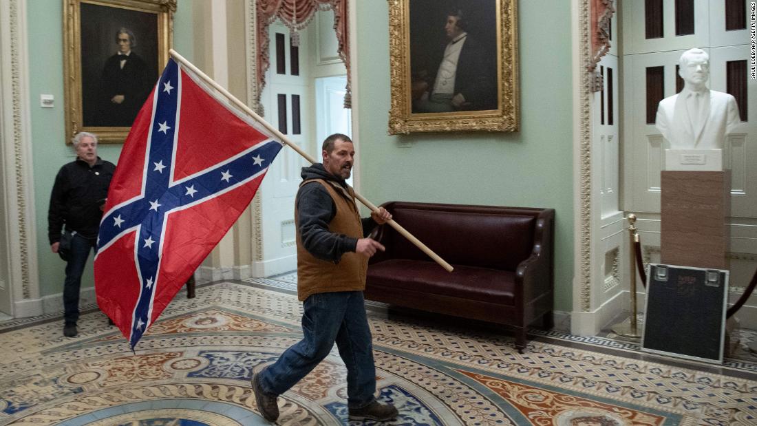Capitol riot investigation: FBI wants your help in identifying the man who carries a Confederate flag