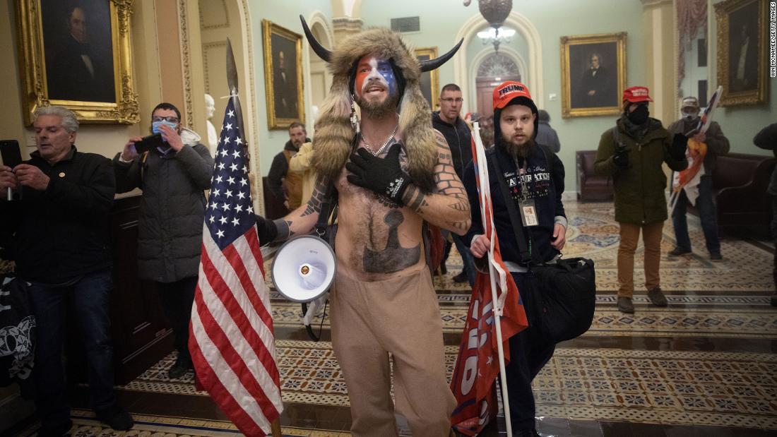 One of &lt;a href=&quot;https://www.cnn.com/2021/01/07/us/insurrection-capitol-extremist-groups-invs/index.html&quot; target=&quot;_blank&quot;&gt;the most recognizable figures in the crowd&lt;/a&gt; was a man in his 30s with a painted face, fur hat and a helmet with horns. The protester, Jake Angeli — known by followers as the QAnon Shaman — quickly became a symbol of the bizarre and frightening spectacle. In recent months, Angeli has been a regular presence at pro-Trump protests in Arizona, including demonstrations outside the Maricopa County vote-counting center.