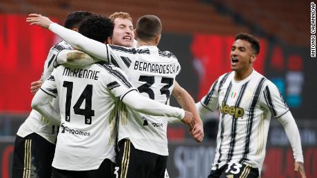 Juventus&#39; McKennie celebrates with teammates after scoring his side&#39;s third goal against AC Milan.