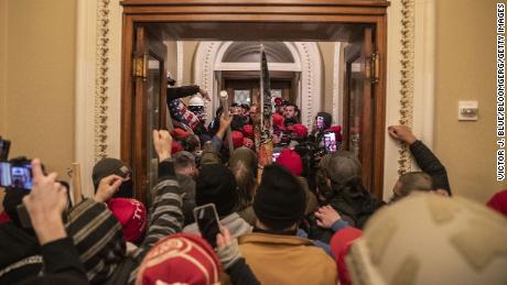 Demonstrators walk through the U.S. Capitol after breaching barricades to the building during a protest outside of in Washington, D.C., U.S., on Wednesday, Jan. 6, 2021.