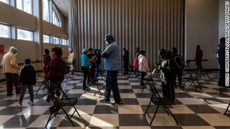 Voters stand in line to cast ballots during the Senate runoff elections in Atlanta on January 5. Georgia voters turned out in record numbers to elect two Democrats and swing the balance of power in the US Senate.