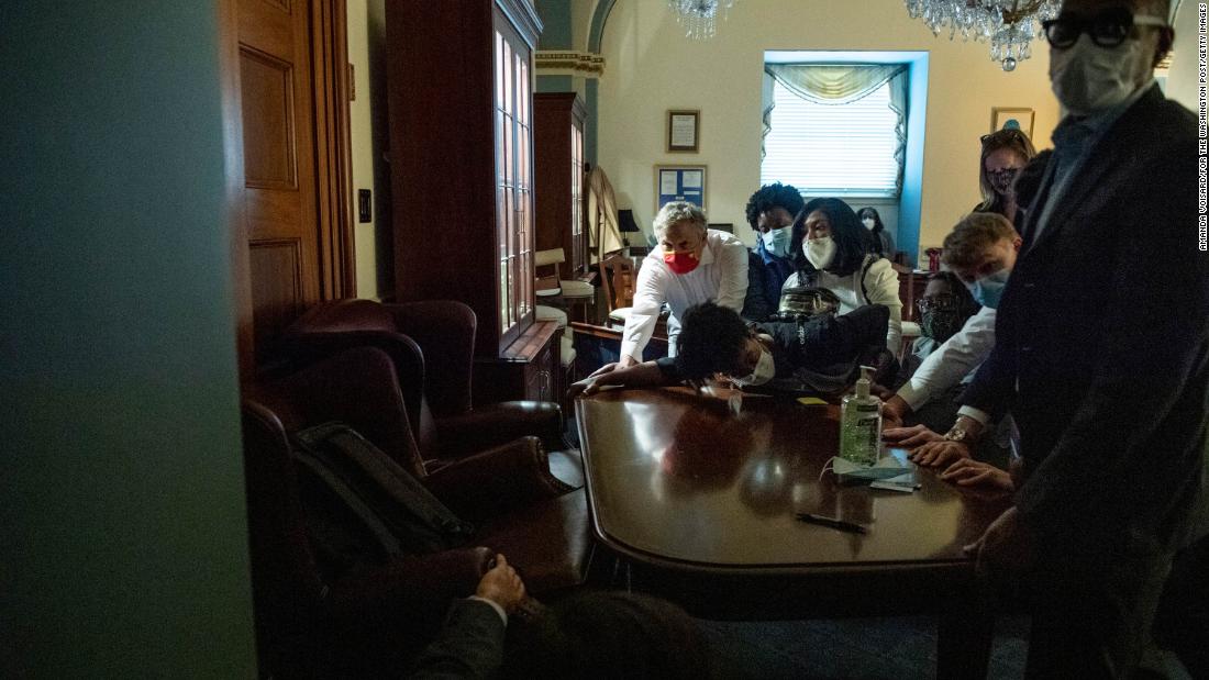 Congressional staffers put up a barricade inside the Capitol after rioters breached the building.