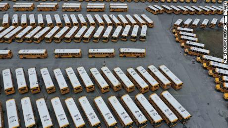 About 200 school buses are parked at a bus depot in Clarksburg, Maryland, on March 16, 2020, idled by the statewide closing of schools in response to the  coronavirus outbreak.