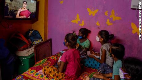 Children attend a tele-learning class at their home via the Kalvi TV channel, an initiative set up to help students while schools are closed by the pandemic in Chennai, India, on July 15, 2020.