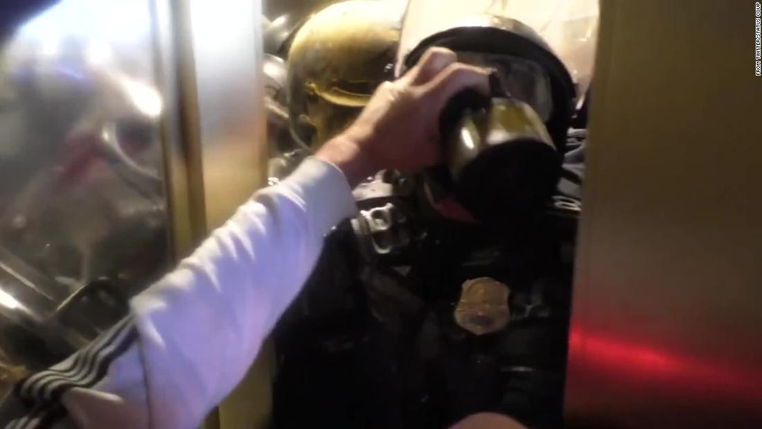 Disturbing video shows policeman smashed against the door by a crowd invading the Capitol