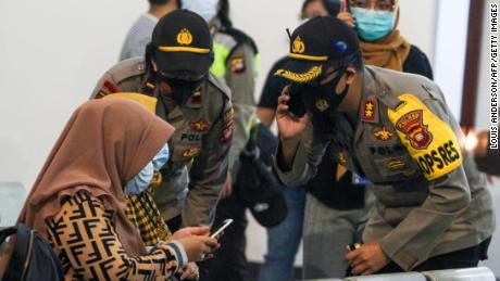 Relatives of passengers on board missing Sriwijaya Air Flight 182 wait for news at Supadio International Airport in Pontianak on Saturday.