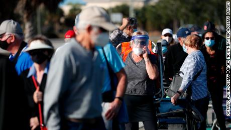 Seniors and first responders wait in line to receive a vaccine in Fort Myers, Florida on December 30.