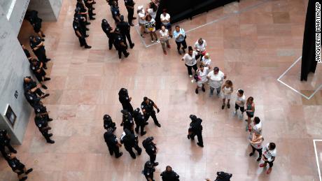 Protesters line up as they&#39;re arrested in the Hart Senate Office Building.