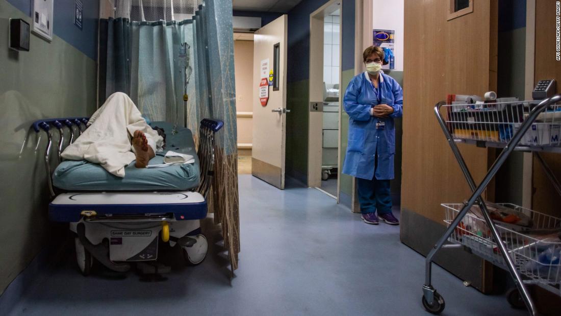 A patient rests in a corridor, waiting for a room at Providence Cedars-Sinai Tarzana Medical Center, a hospital in Tarzana, California, on January 3.
