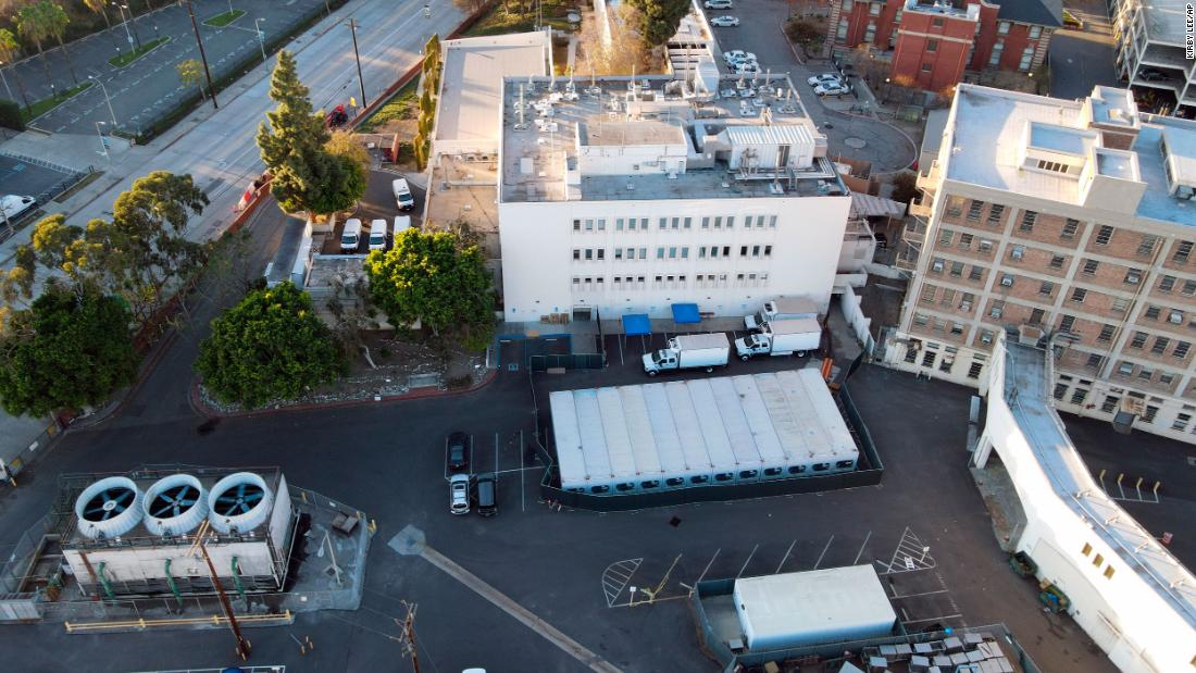 Refrigerated trailers are parked outside the office of the Los Angeles County coroner on January 10. They are acting as temporary morgues.