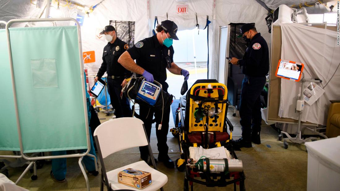An emergency medical technician packs up equipment after transferring a suspected Covid-19 patient to a field hospital tent outside the emergency department of the Martin Luther King Jr. Community Hospital in Los Angeles on January 6.