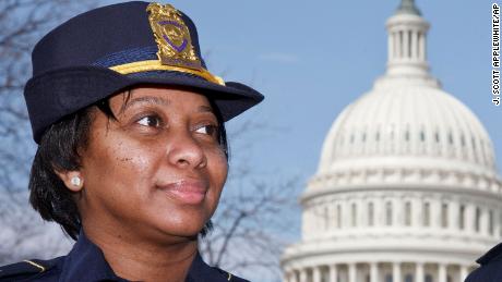 Officers Yogananda &quot;Yogi&quot; Pittman, left, and Monique Moore, right, the first two African-American women to be promoted to the rank of captain on the U.S. Capitol Police force, stand together on the East Lawn of the Capitol in Washington, Monday, March 19, 2012. (AP Photo/J. Scott Applewhite)