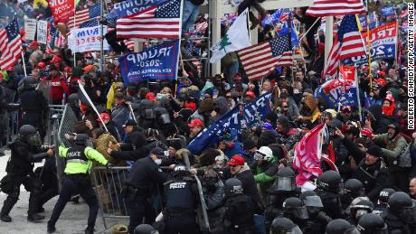 Trump supporters clash with police and security forces as they push barricades to storm the US Capitol in Washington D.C on January 6, 2021. 