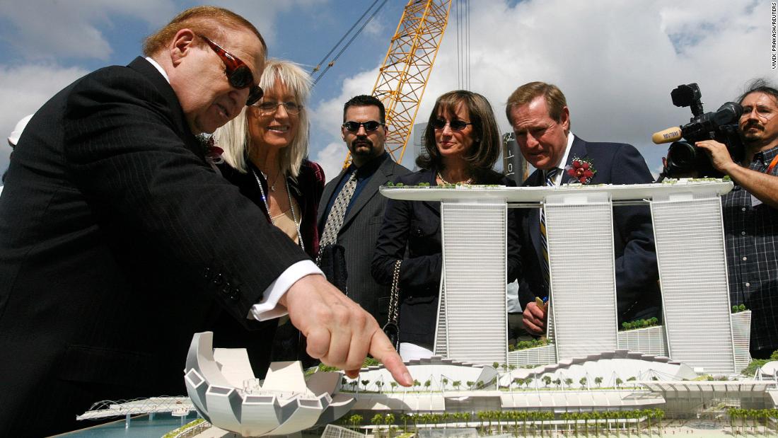 Adelson points at a model of the Marina Bay Sands casino during a groundbreaking ceremony in Singapore in 2007.