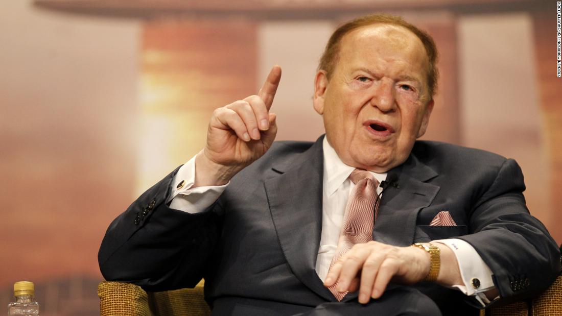 Adelson speaks to the media in Singapore in 2011. In person, Adelson was instantly recognizable for his thinning patch of bright red hair and the electric scooter he rode everywhere. He suffered from peripheral neuropathy, a condition that made walking difficult.