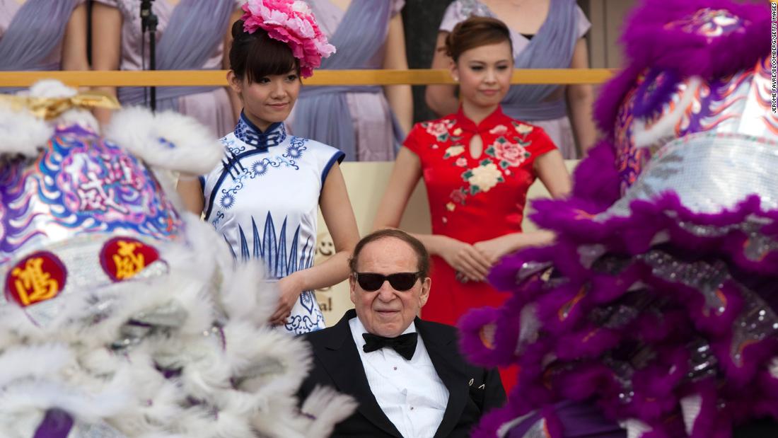 Adelson watches a traditional lion dance in Macao during the opening of the Sands Cotai Central resort in 2012.