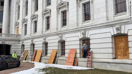 Workers begin boarding up the Wisconsin state Capitol building in Madison on Monday, Jan. 11, 2021. State officials are concerned about the prospects of state-centered violence in the wake of last week&#39;s security breaches at the U.S. Capitol. (AP Photo/Todd Richmond)