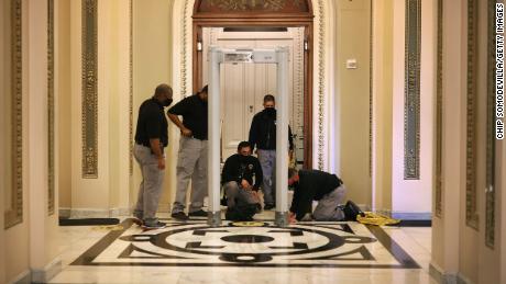 WASHINGTON, DC - JANUARY 12: U.S. Capitol Police install a metal detector outside the House of Representatives Chamber, on the very spot where less than a week earlier violent insurrectionists attempted to smash their way through and halt the certification of the Electoral College votes, January 12, 2021 in Washington, DC. At the direction of President Donald Trump, the mob attacked the U.S. Capitol on January 6 and security has been tightened ahead of next week&#39;s presidential inauguration. (Photo by Chip Somodevilla/Getty Images)